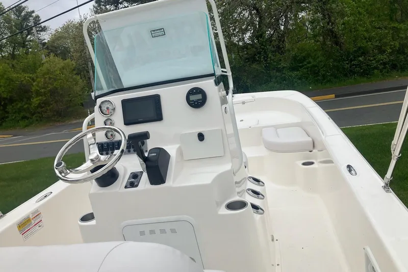 Slide: The Image of 2026 Sundance DX22 boat interior with steering wheel and dashboard controls. - 4