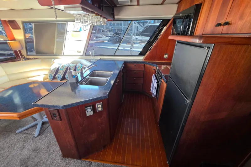 Slide: The Image of 1985 Bayliner 4550 Motoryacht interior kitchen with wood cabinetry and modern appliances. - 11