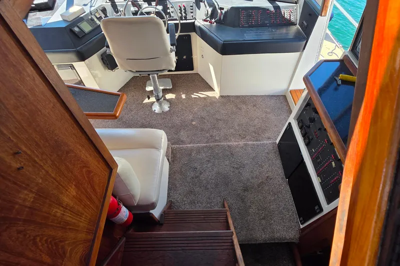 Slide: The Image of Interior of 1985 Bayliner 4550 Motoryacht with helm, seating, and control panels. - 18