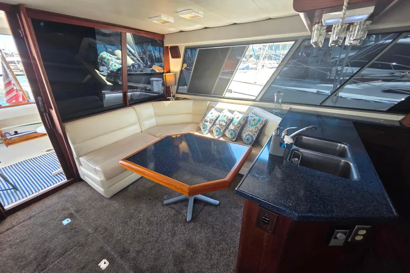Slide: The Image of Interior of 1985 Bayliner 4550 Motoryacht with seating, table, and kitchenette. - 2