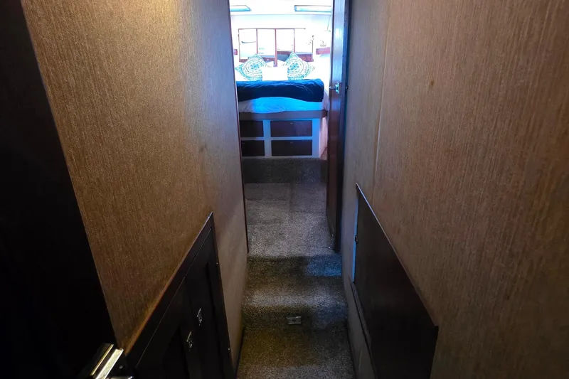 Slide: The Image of Interior hallway of 1987 Bayliner 4550 Motoryacht leading to a cozy bedroom. - 26