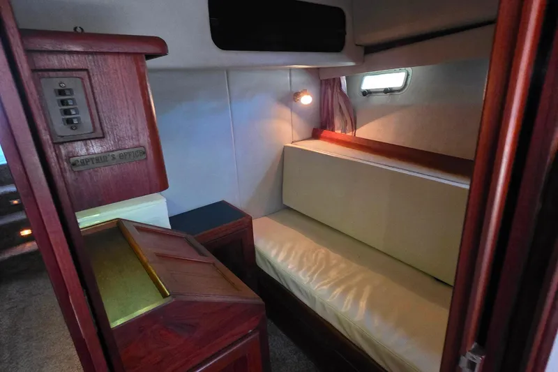 Slide: The Image of Interior of 1985 Bayliner 4550 Motoryacht with cozy seating and wooden accents. - 33