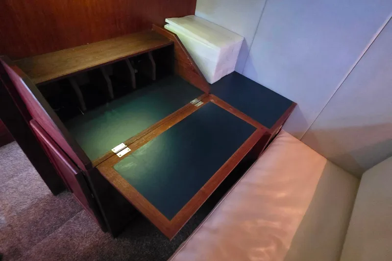 Slide: The Image of Interior of 1985 Bayliner 4550 Motoryacht with wooden desk and cushioned seating. - 34