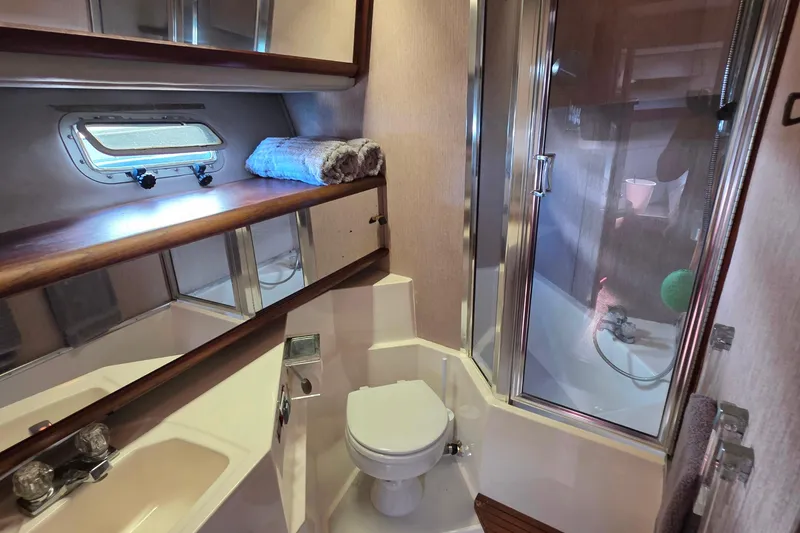 Slide: The Image of 1985 Bayliner 4550 Motoryacht bathroom with shower, sink, and porthole window. - 38