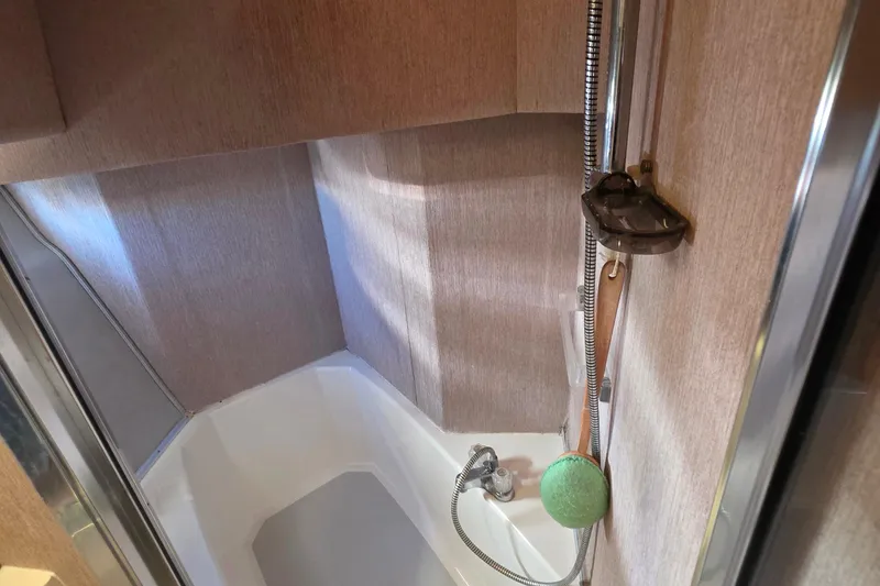 Slide: The Image of 1985 Bayliner 4550 Motoryacht bathroom with shower and wooden paneling. - 39