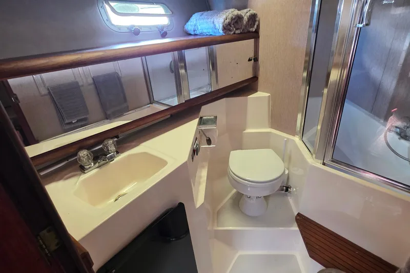 Slide: The Image of 1985 Bayliner 4550 Motoryacht bathroom with sink, toilet, and shower. - 40