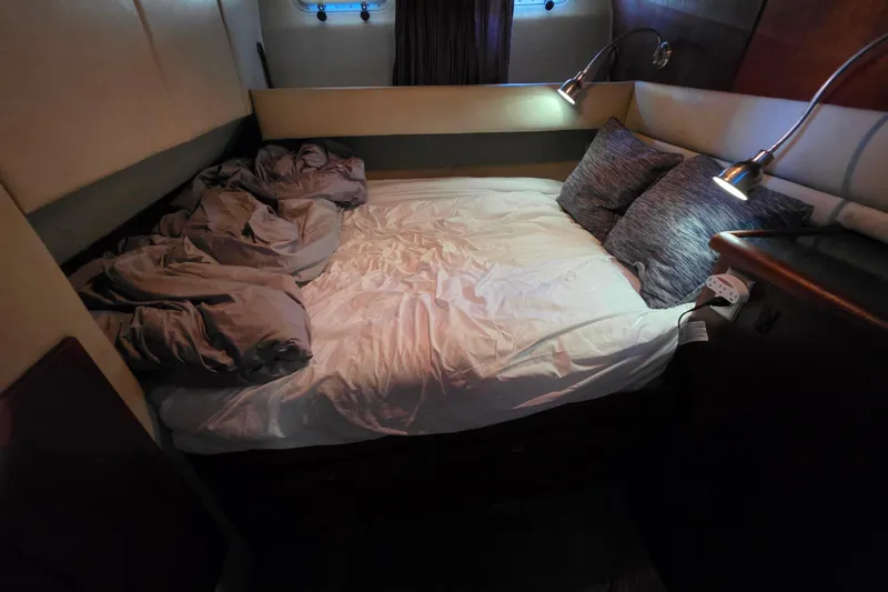 Slide: The Image of Cozy bedroom interior of 1985 Bayliner 4550 Motoryacht with bed and reading lights. - 43