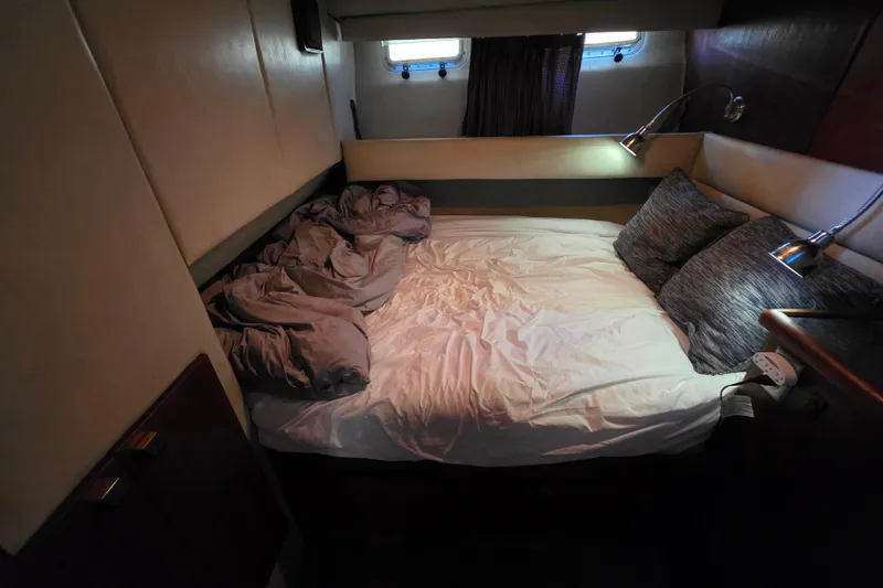 Slide: The Image of Cozy bedroom interior of 1985 Bayliner 4550 Motoryacht with bed and reading lights. - 44