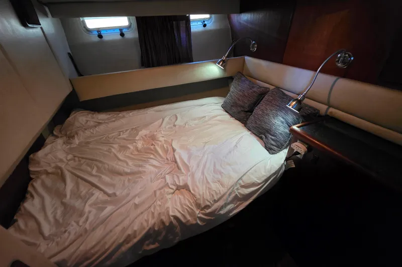 Slide: The Image of Cozy bedroom interior of 1985 Bayliner 4550 Motoryacht with bed and reading lights. - 45