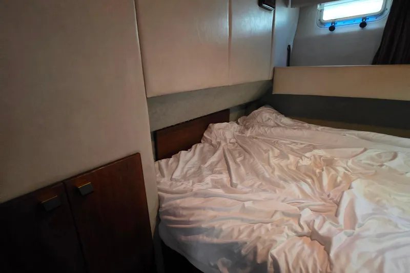 Slide: The Image of Interior cabin of 1985 Bayliner 4550 Motoryacht with unmade bed and window. - 46