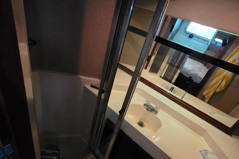 Slide: The Image of Bathroom interior of 1985 Bayliner 4550 Motoryacht with sink and mirror. - 48