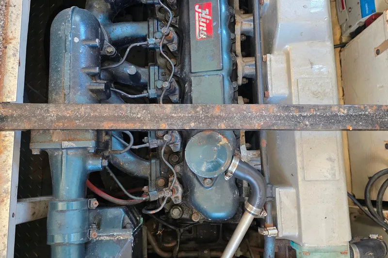 Slide: The Image of Engine compartment of a 1985 Bayliner 4550 Motoryacht, showcasing mechanical components. - 56