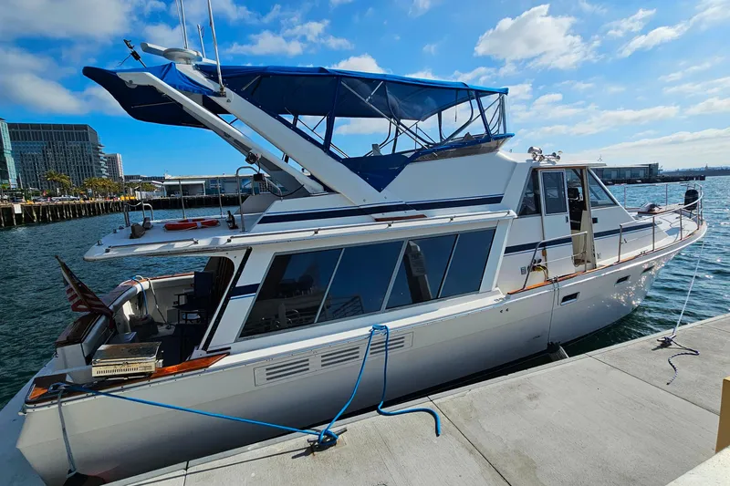 Slide: The Image of 1985 Bayliner 4550 Motoryacht docked at marina under blue sky. - 68