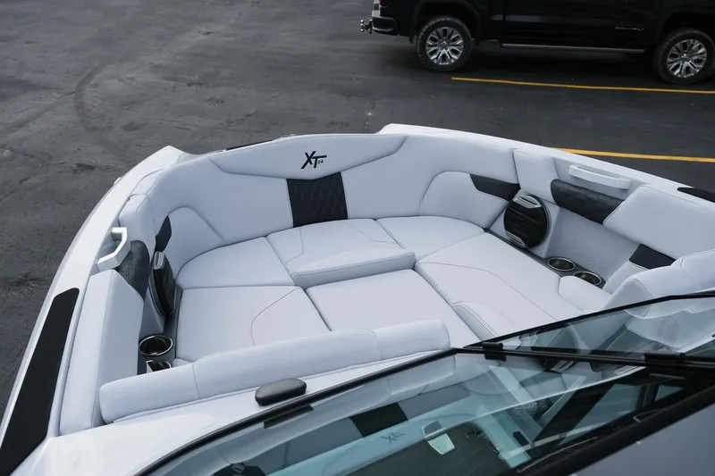 Slide: The Image of 2026 MasterCraft XT24 boat interior with luxurious white seating and cup holders. - 13