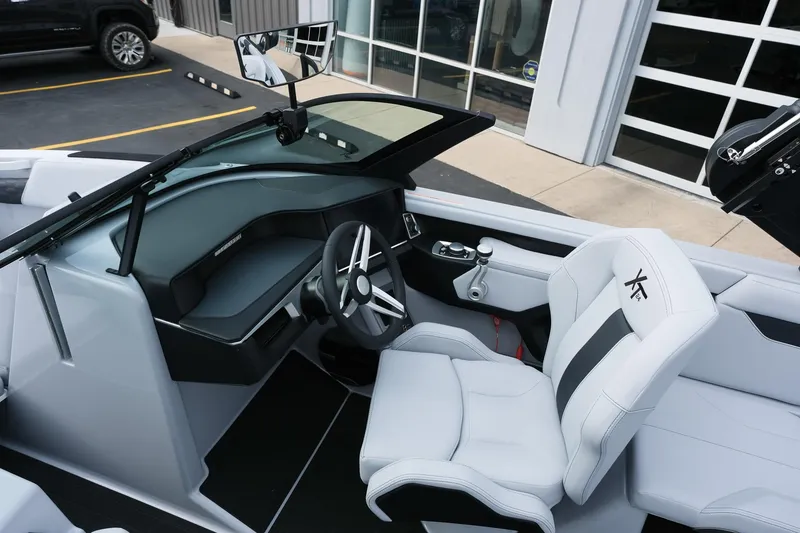 Slide: The Image of 2026 MasterCraft XT24 boat interior with sleek dashboard and modern steering wheel design. - 14