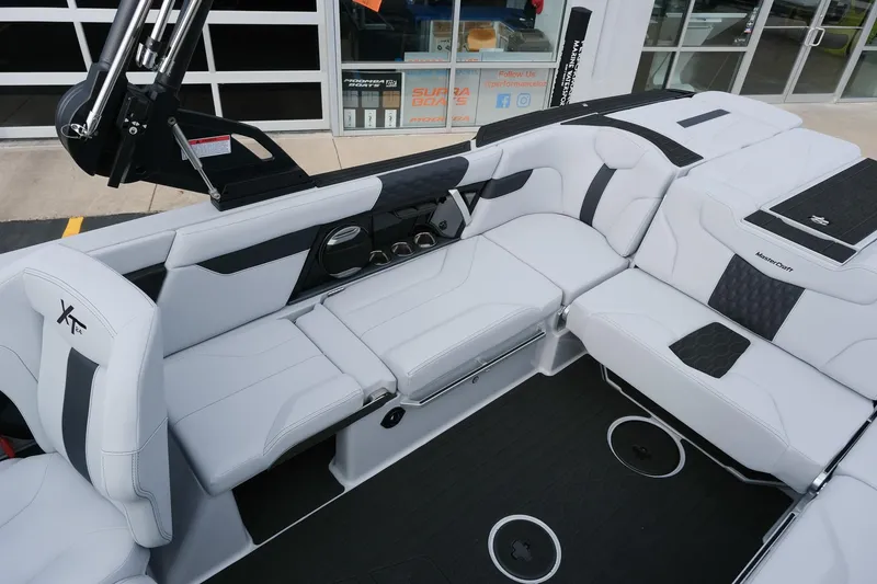 Slide: The Image of 2026 MasterCraft XT24 boat interior with sleek white seating and modern design. - 15