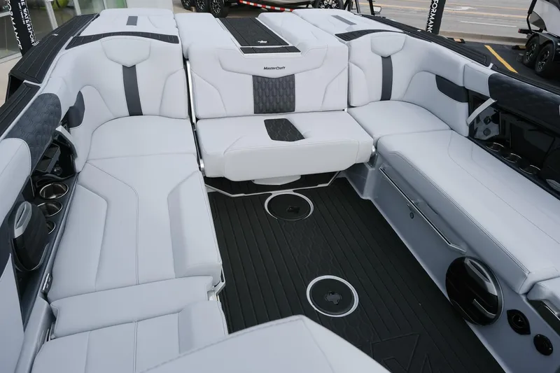 Slide: The Image of 2026 MasterCraft XT24 boat interior with luxurious seating and modern design. - 16