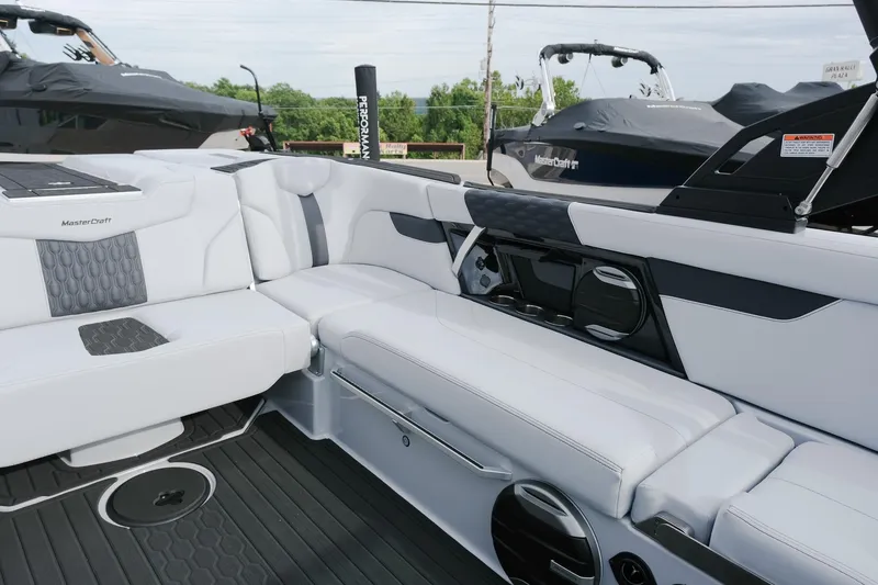 Slide: The Image of 2026 MasterCraft XT24 boat interior with sleek white seating and modern design elements. - 17