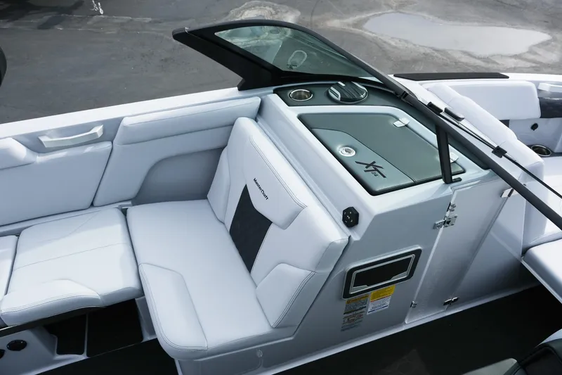 Slide: The Image of 2026 MasterCraft XT24 boat interior with white seating and sleek design. - 18