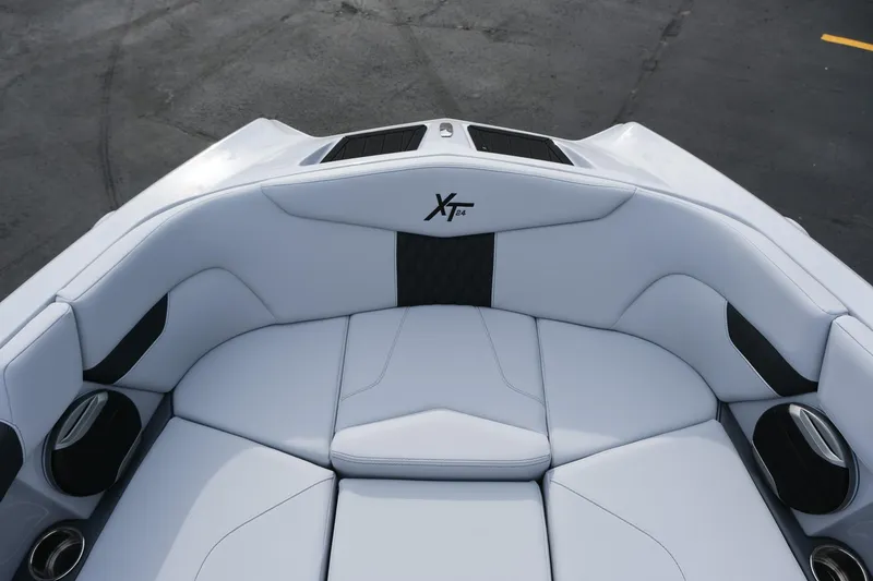 Slide: The Image of 2026 MasterCraft XT24 boat interior with white cushioned seating and sleek design. - 19