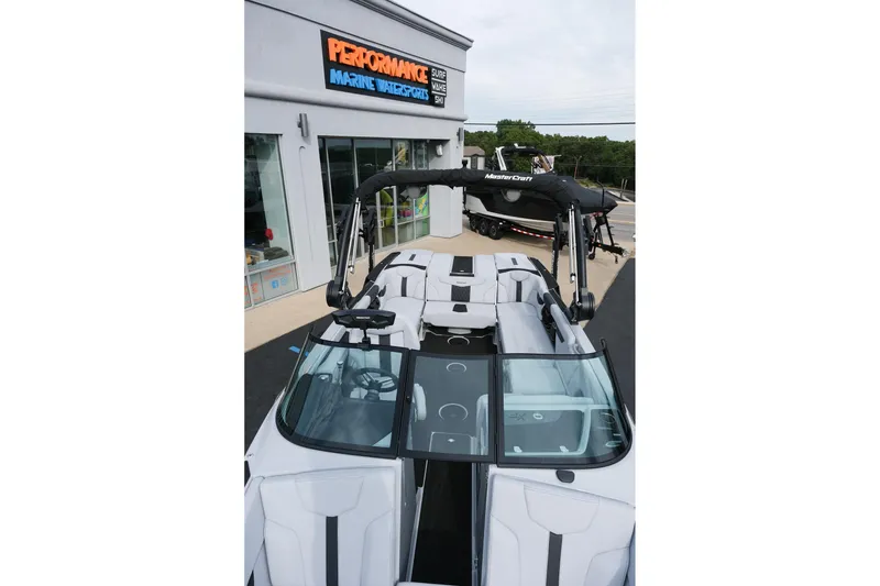 Slide: The Image of 2026 MasterCraft XT24 boat displayed at Performance Marine Watersports dealership. - 20