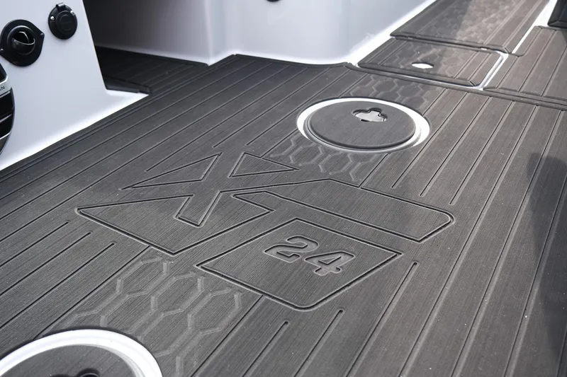 Slide: The Image of 2026 MasterCraft XT24 boat deck with embossed logo and sleek design. - 24
