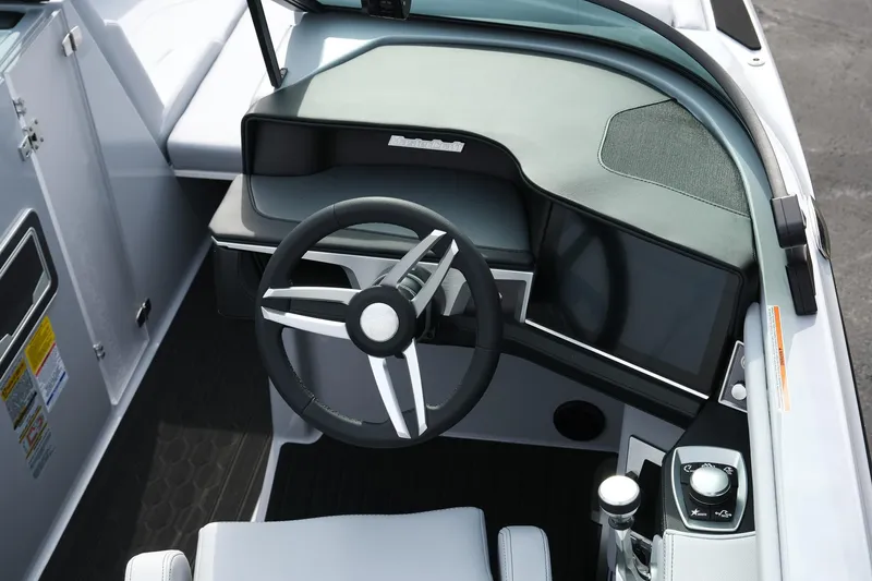 Slide: The Image of 2026 MasterCraft XT24 boat cockpit with modern steering wheel and control panel. - 28