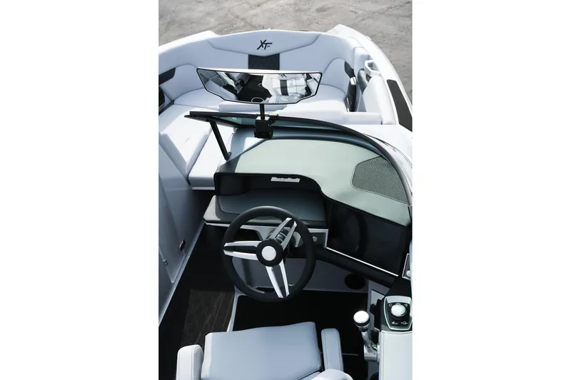 Slide: The Image of 2026 MasterCraft XT24 boat interior with sleek steering wheel and modern dashboard design. - 29