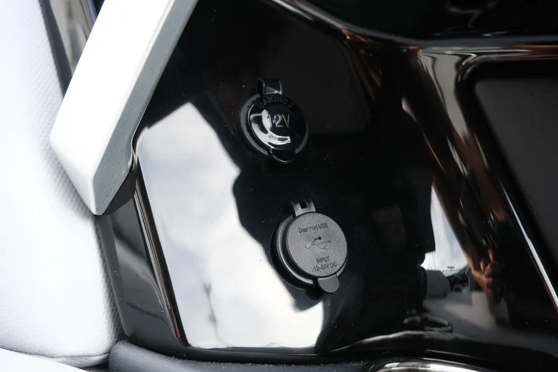 Slide: The Image of 2026 MasterCraft XT24 boat dashboard with 12V and USB dual port outlets. - 34