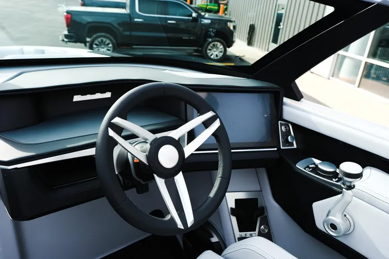Slide: The Image of 2026 MasterCraft XT24 boat interior with modern steering wheel and dashboard controls. - 39