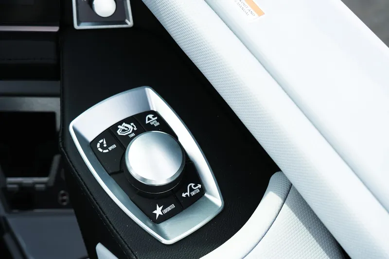 Slide: The Image of 2026 MasterCraft XT24 boat control panel with multifunctional dial and buttons. - 44