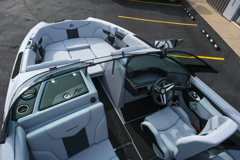 Slide: The Image of 2026 MasterCraft XT24 boat interior with sleek seating and modern dashboard design. - 47