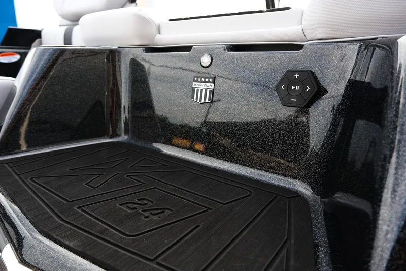 Slide: The Image of 2026 MasterCraft XT24 boat interior with control panel and logo detail. - 49