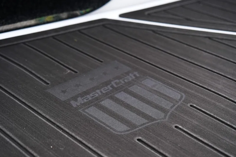 Slide: The Image of Close-up of 2026 MasterCraft XT24 boat floor mat with logo and stripes. - 50