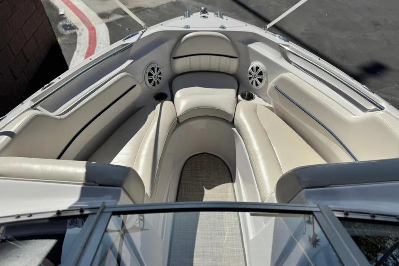 Slide: The Image of Bow seating area of a 2010 Four Winns H210 boat with beige upholstery. - 11