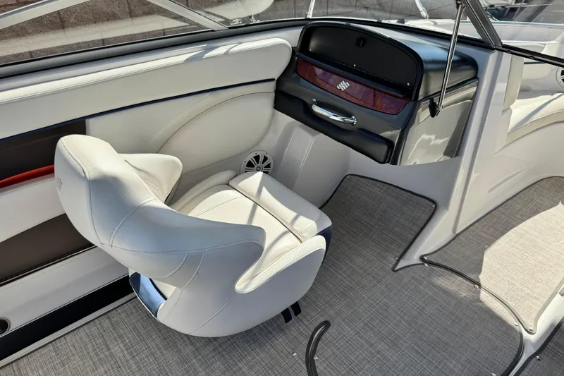 Slide: The Image of Interior of 2010 Four Winns H210 boat with white seating and sleek dashboard design. - 19