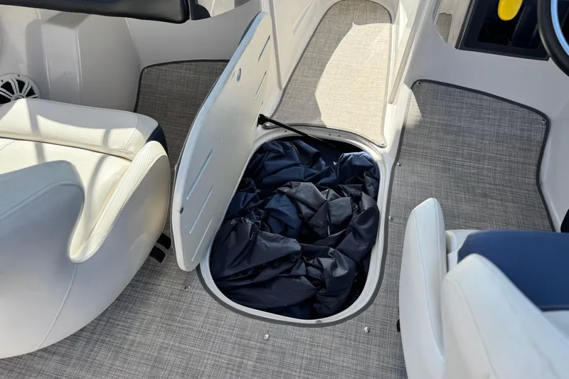 Slide: The Image of 2010 Four Winns H210 boat interior with open storage compartment and seating. - 20