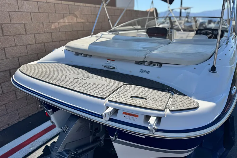 Slide: The Image of 2010 Four Winns H210 boat with swim platform and cushioned seating. - 6