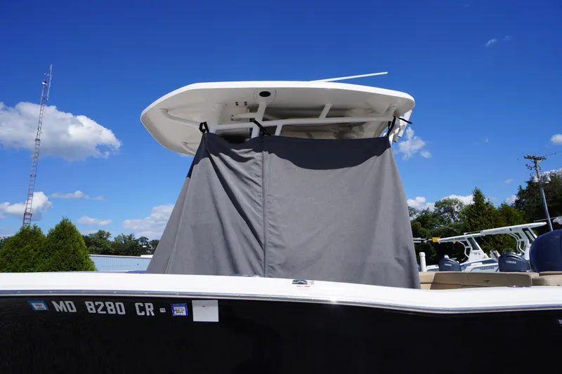 Slide: The Image of 2016 Tidewater 220 LXF boat with T-top and cover under a clear blue sky. - 1