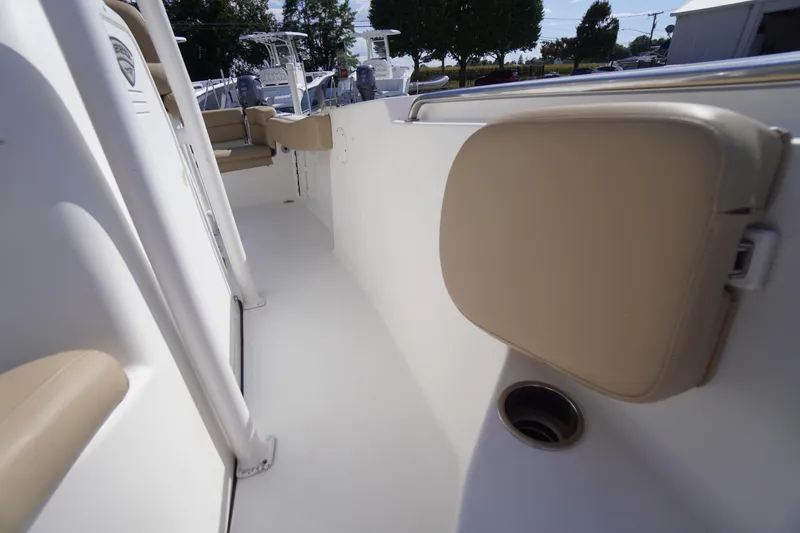 Slide: The Image of 2016 Tidewater 220 LXF boat interior with beige seating and white deck. - 14