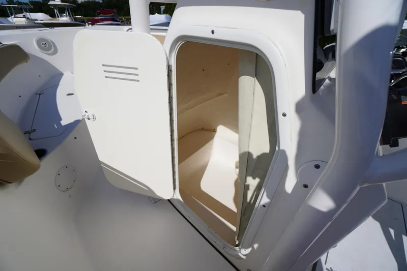 Slide: The Image of 2016 Tidewater 220 LXF boat storage compartment with open door. - 15