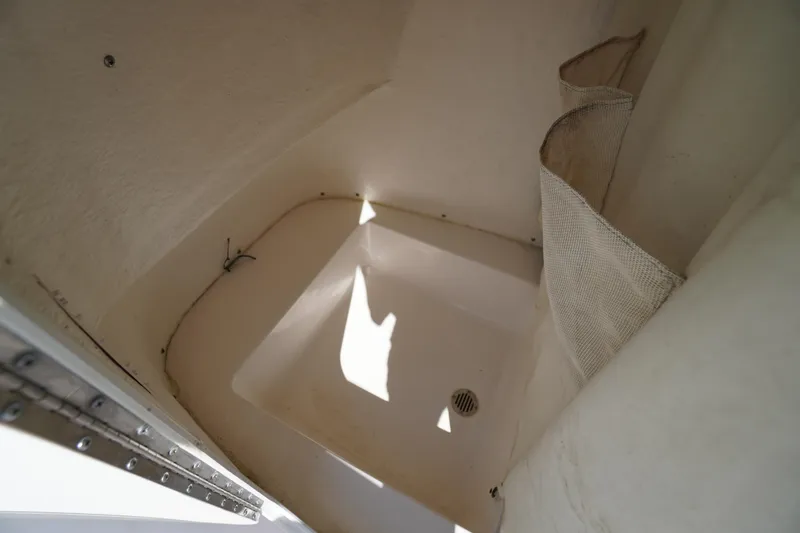 Slide: The Image of Interior storage compartment of 2016 Tidewater 220 LXF boat, featuring netted storage pockets. - 16