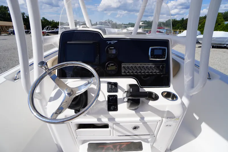 Slide: The Image of 2016 Tidewater 220 LXF boat console with steering wheel and control panel. - 18