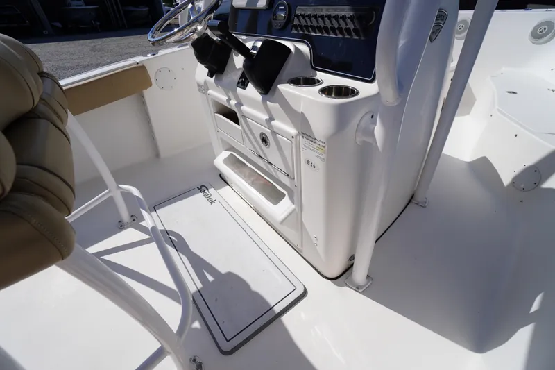 Slide: The Image of 2016 Tidewater 220 LXF boat interior with console and seating area. - 20