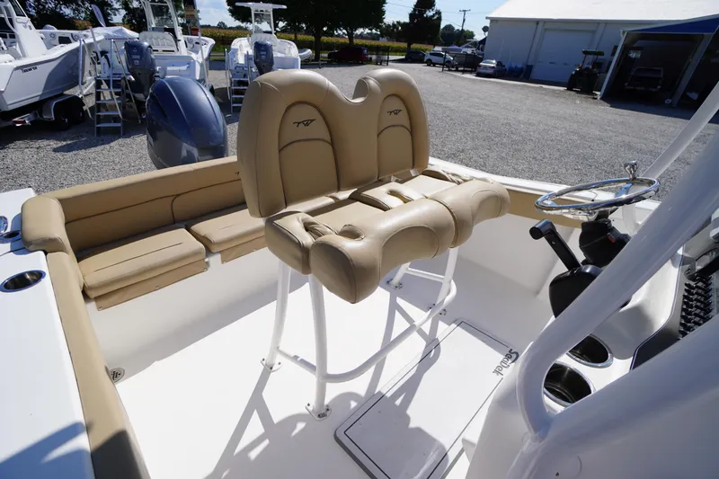Slide: The Image of 2016 Tidewater 220 LXF boat interior with tan seating and steering wheel. - 21