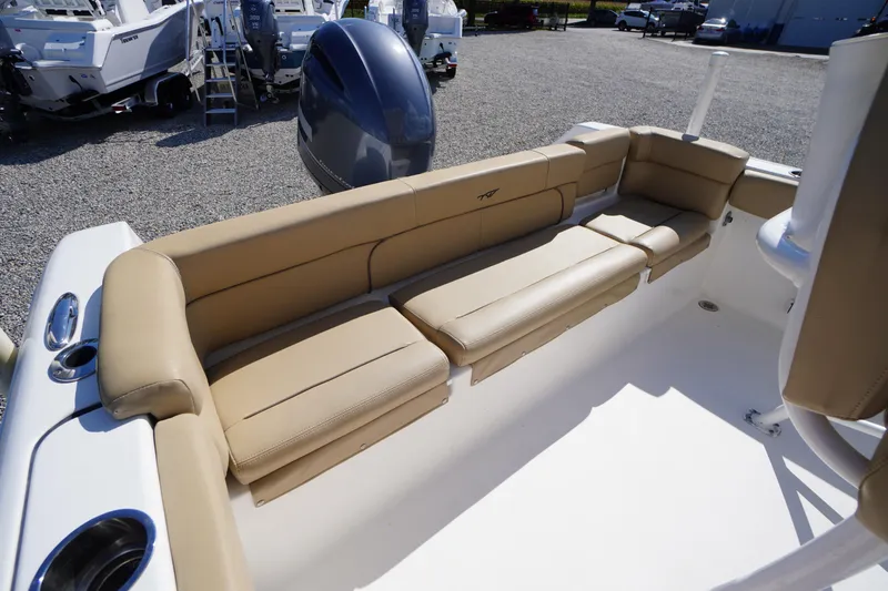 Slide: The Image of 2016 Tidewater 220 LXF boat interior with tan seating and outboard motor. - 24