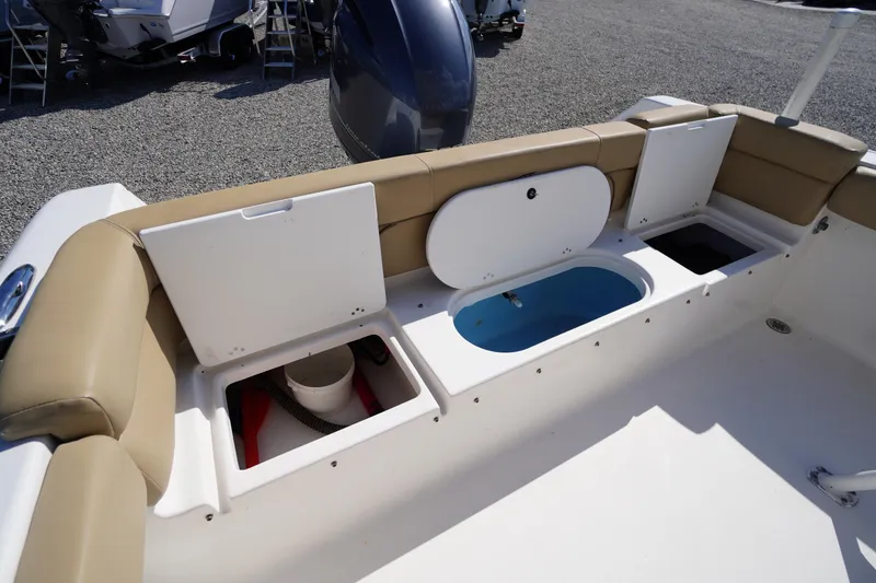 Slide: The Image of 2016 Tidewater 220 LXF boat interior with storage compartments and seating. - 25