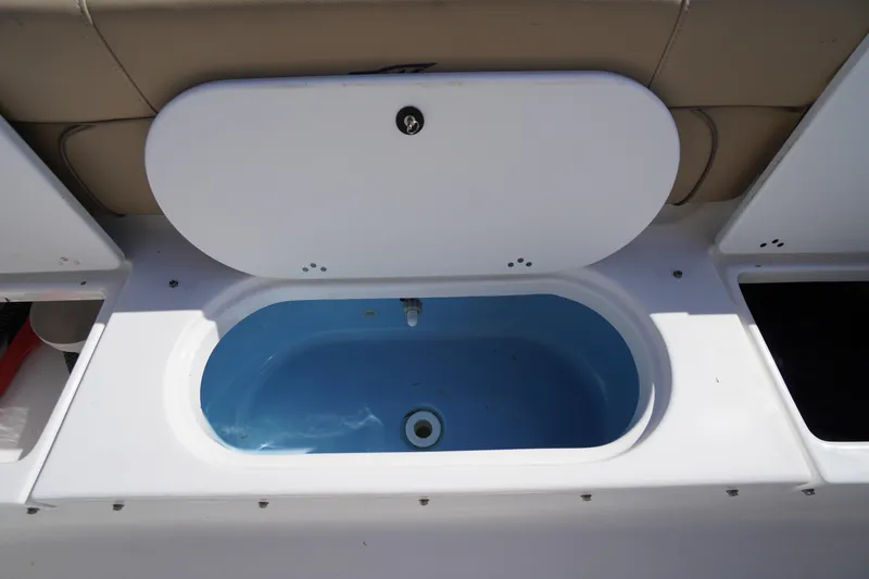 Slide: The Image of Livewell on 2016 Tidewater 220 LXF boat, featuring a blue interior and white lid. - 28