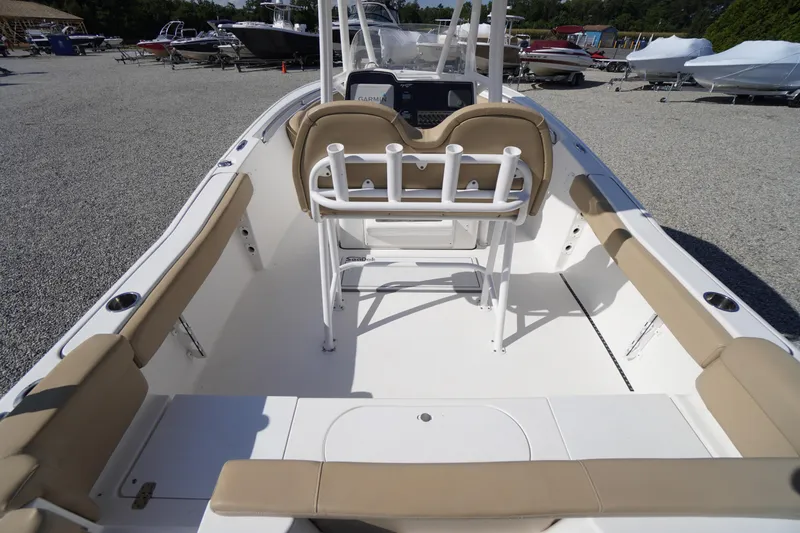 Slide: The Image of 2016 Tidewater 220 LXF boat interior with beige seating and white deck. - 29