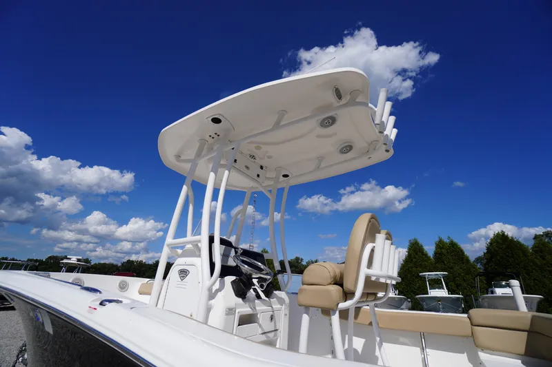 Slide: The Image of 2016 Tidewater 220 LXF boat under clear blue sky with white clouds. - 3